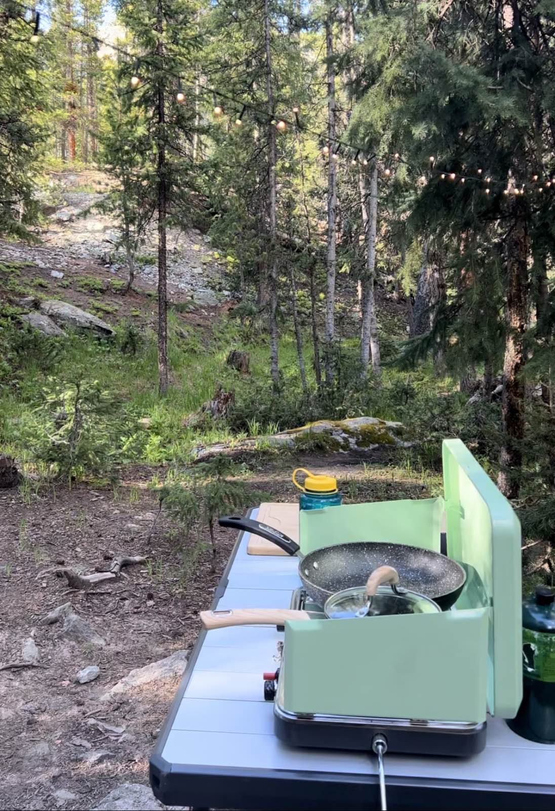 A camp prep table set up with cooking gear at a campsite.