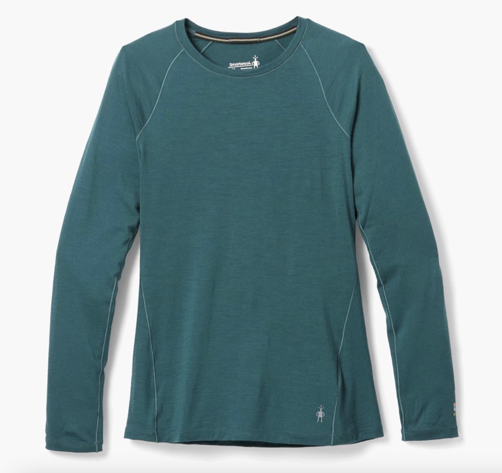 A merino wool base layer top laid flat.