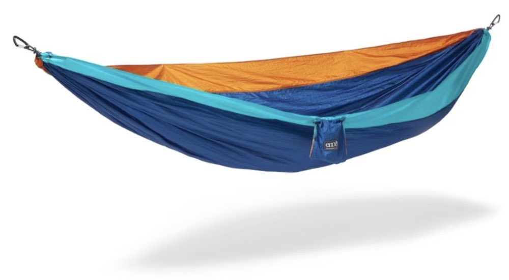 An ENO DoubleNest camping hammock strung between two trees.