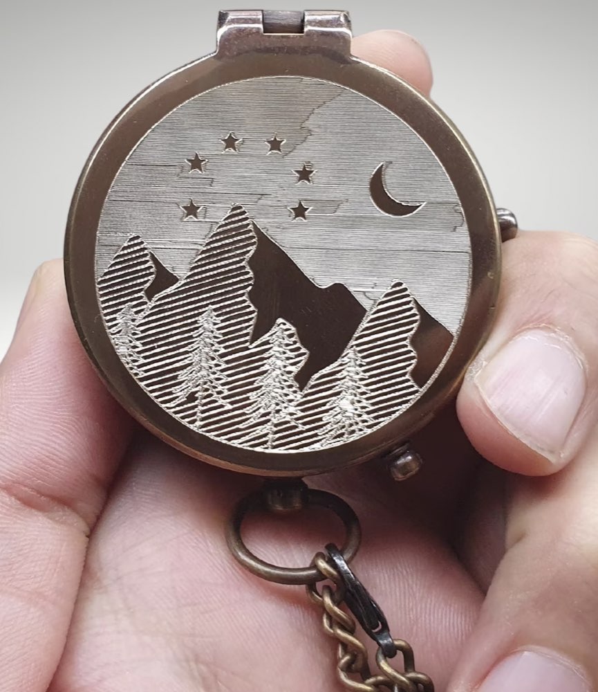 An engraved brass mountain compass, a personalized outdoor gift.