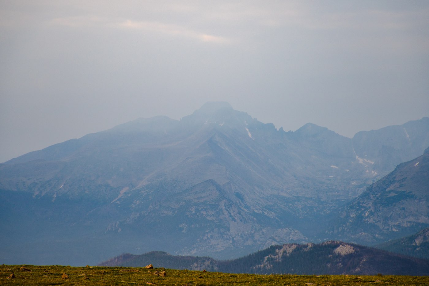 A hazy view of a distant Colorado mountain range.