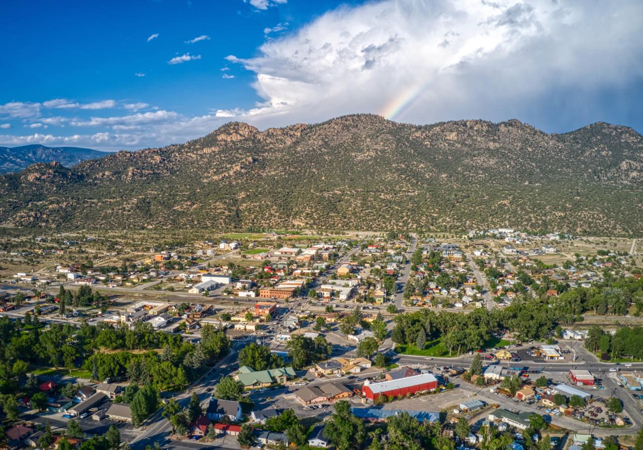 An aerial view of downtown Buena Vista with a rainbow over the mountains behind it.